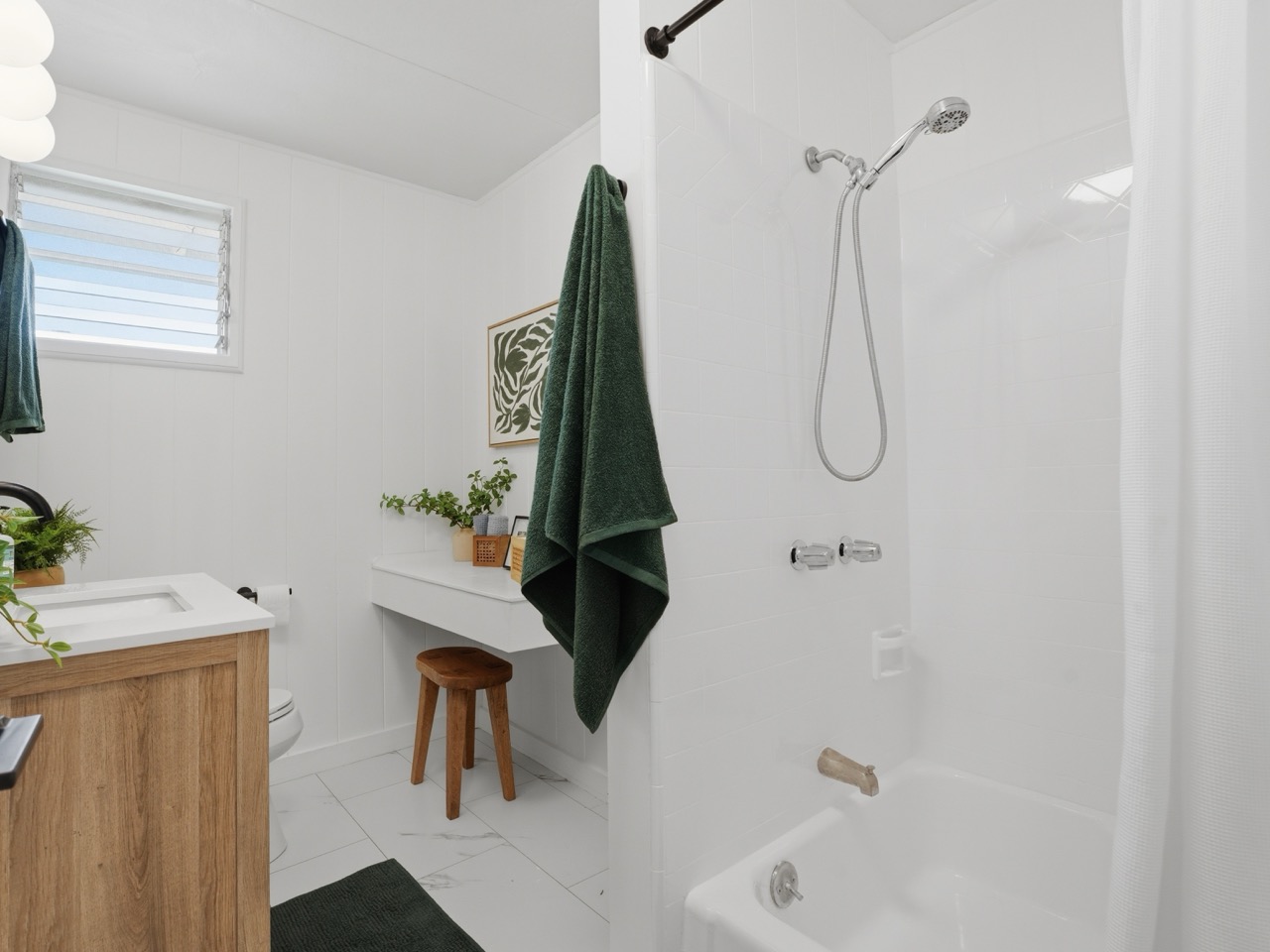 Bathroom with tub, shower and floating wood vanity