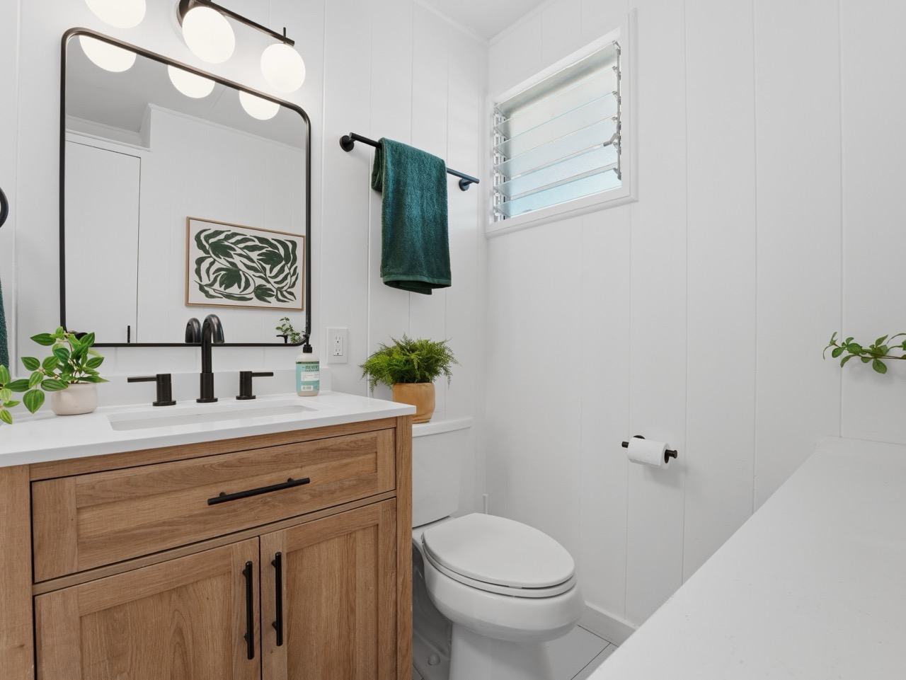 Bathroom vanity with wood cabinet and globe vanity lights