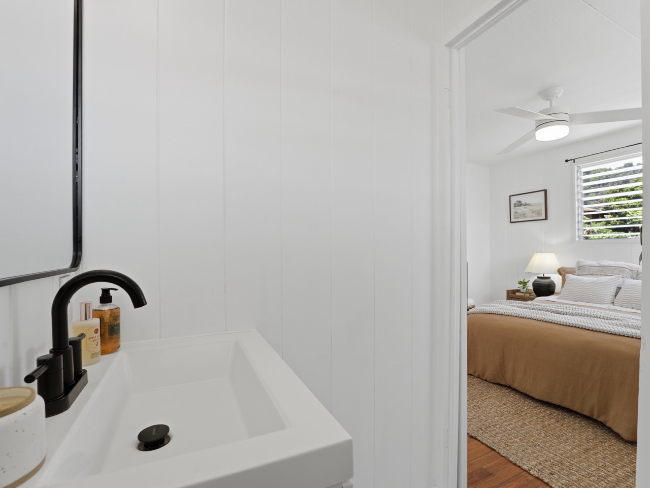 Bathroom vanity looking through to a bedroom