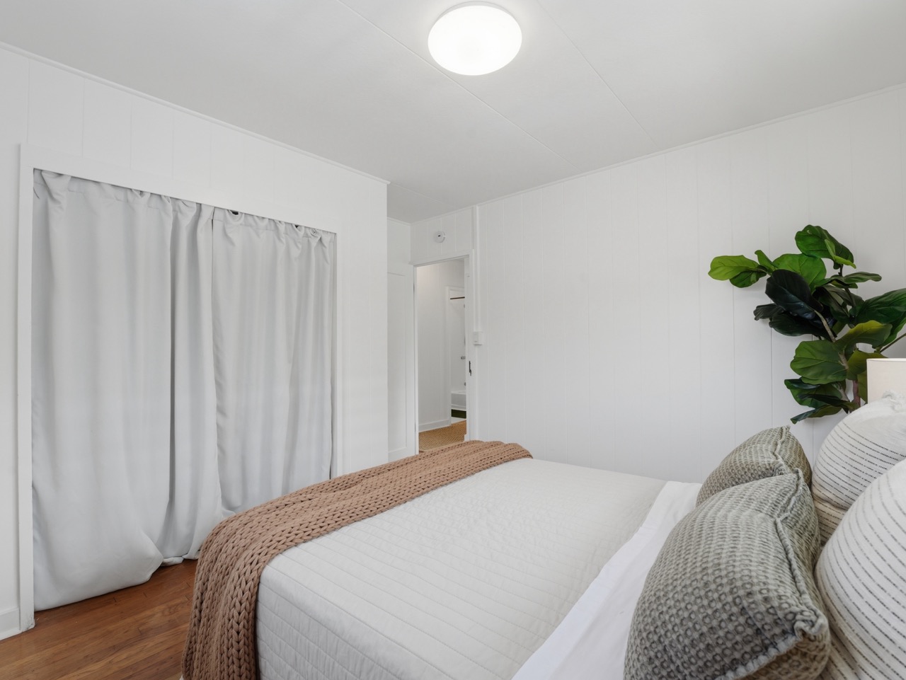Cozy bedroom corner with closet and fiddle leaf fig