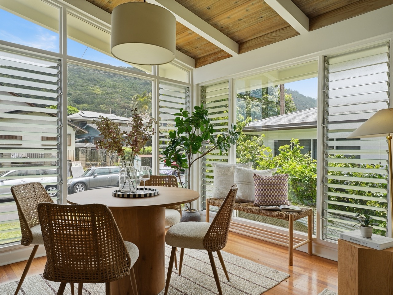 Sun-filled dining area with mountain and street views