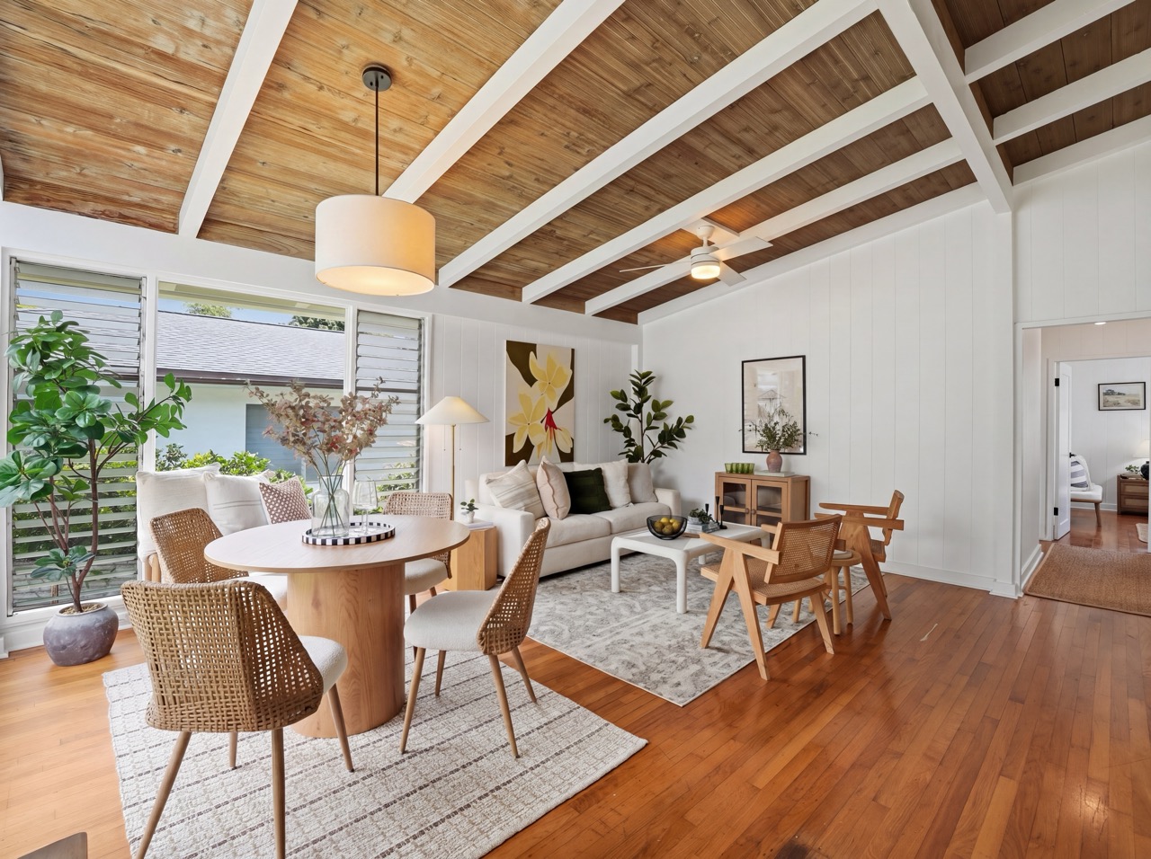 Living room with vaulted wood-panel ceiling and hardwood floors