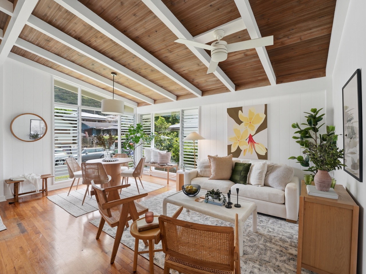 Bright living room with sofa, art and louvered windows