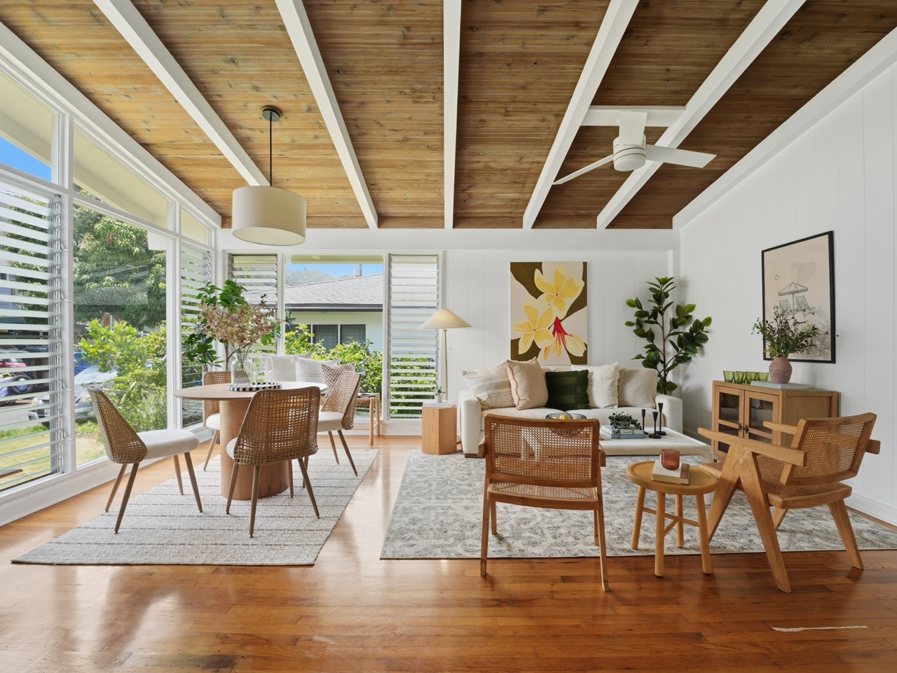 Bright open living and dining room with beamed wood ceiling