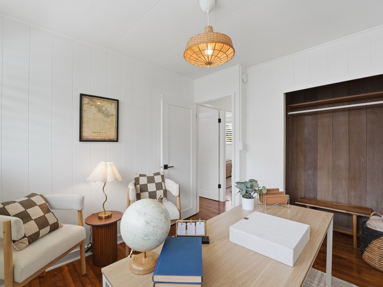 Home office with globe, checkered pillows and Honolulu map art
